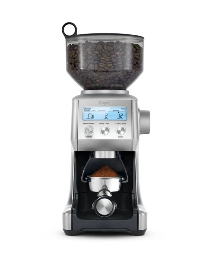 The Sage The Smart Grinder Pro Coffee Grinder in sleek silver has a transparent bean hopper and conical burr grinder. Its digital display offers multiple settings, and Dosing IQ technology ensures freshly ground coffee fills the portafilter.