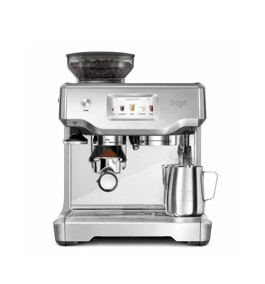 The sleek, silver Sage The Barista Touch Express Espresso Machine by Sage features a touch screen display, a built-in top grinder, and a side steam wand. A small metal milk pitcher is conveniently placed on the drip tray.