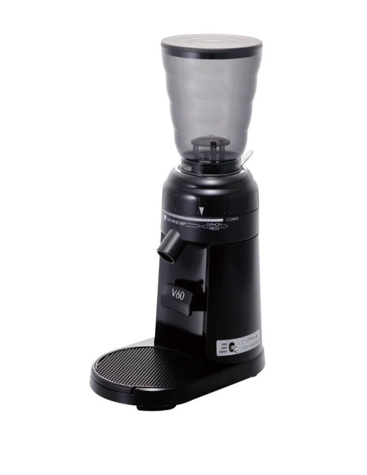 The Hario V60 Electric Coffee Grinder is a sleek, modern black grinder featuring a transparent bean hopper, circular tray, and a control dial for grind-size settings. Its compact design proudly showcases the Hario V60 label.