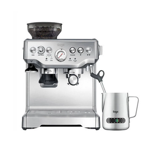 The Sage The Barista Express Espresso Machine, silver and featuring a built-in grinder, steam wand, pressure gauge, and precise temp control, comes with a branded milk frothing jug with temperature gauge—ideal for coffee aficionados.