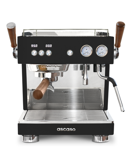 Ascaso Baby T Flow professional rotary pump espresso machine with dual steam and hot water wands, wood-accented portafilter and handles, and two circular pressure gauges on the front.