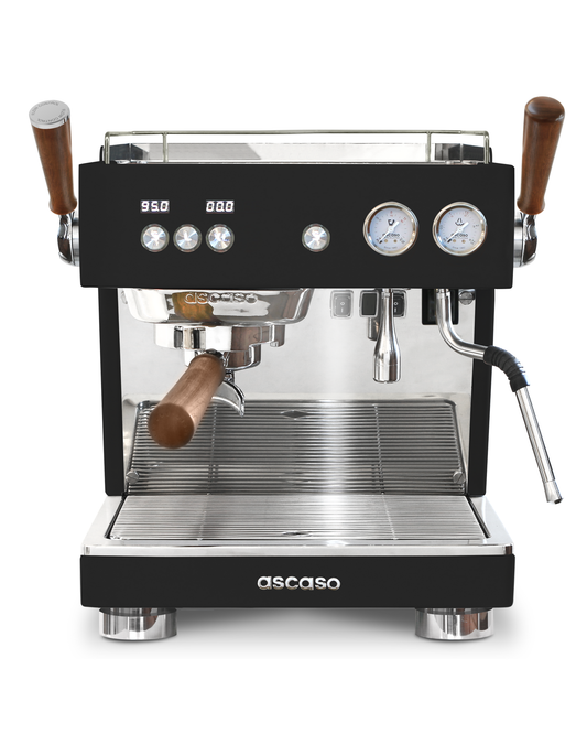 Ascaso Baby T Flow professional rotary pump espresso machine with dual steam and hot water wands, wood-accented portafilter and handles, and two circular pressure gauges on the front.