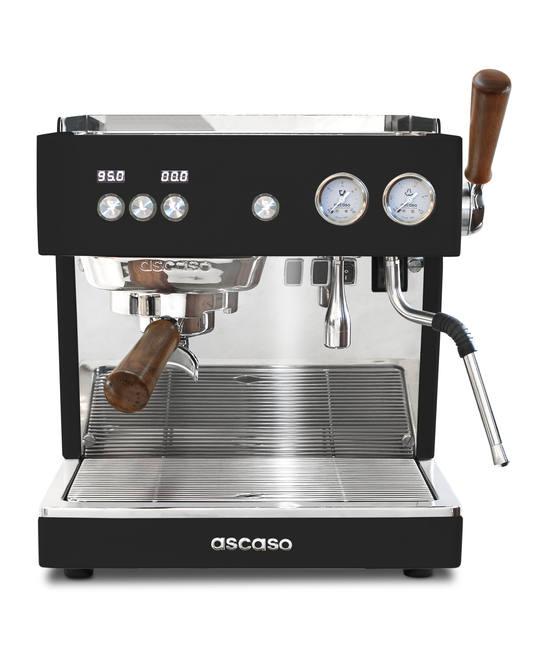 Professional black Ascaso Baby T Plus espresso machine with a portafilter and steam wand featuring wooden handles, digital temperature displays, dual pressure gauges, and a rotary pump.