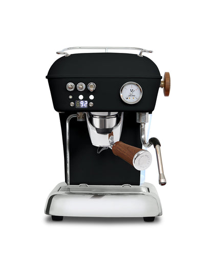 Black Ascaso Dream PID espresso machine with a wooden portafilter handle, steam wand, pressure gauge, and a digital temperature display for barista-level coffee.